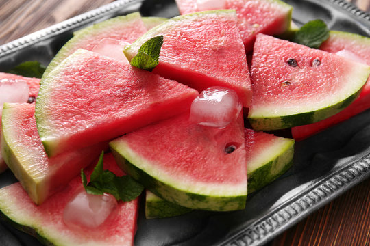 Tray with tasty sliced watermelon on table