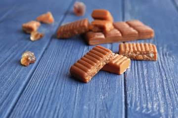 Sweet caramel candies on wooden table