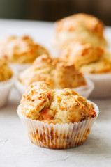 Homemade savory muffins with fish and cheese on a white stone background. Healthy snack or breakfast meal.