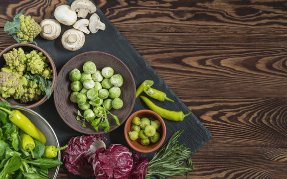 Variety of organic fresh vegetables on wooden background
