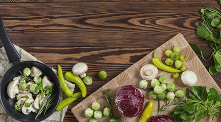 Variety of organic fresh vegetables on wooden background