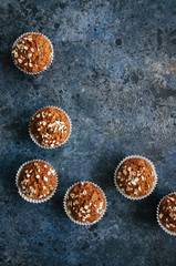 Healthy carrot cake muffins on a blue stone background. Top view.