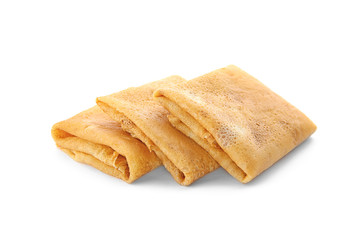 Delicious thin pancakes on white background