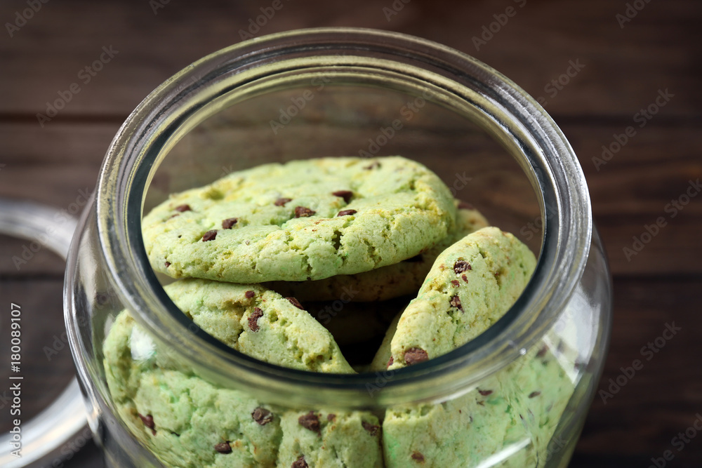 Wall mural Mint chocolate chip cookies in glass jar, closeup