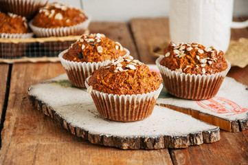 Healthy carrot cake muffins on a wooden board.