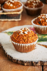 Healthy carrot cake muffins on a wooden board.