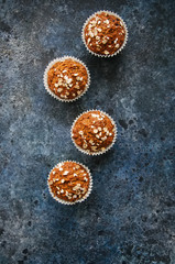 Healthy carrot cake muffins on a blue stone background. Top view.