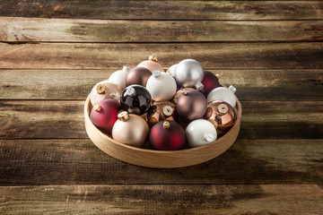 Christmas concept with a tray of baubles on retro wood