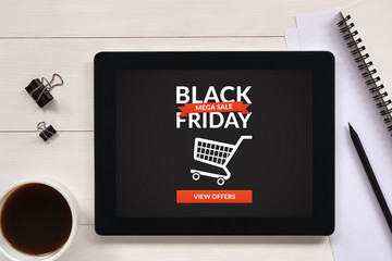Black Friday concept on tablet screen with office objects on white wooden table. All screen content is designed by me. Flat lay
