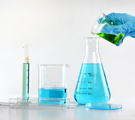 Chemist formulating dangerous solution substances, Scientist with equipment and science experiments, Laboratory glassware containing toxic chemical liquid.