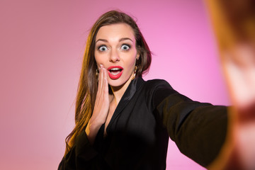 surprised woman taking selfie
