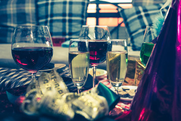 Christmas party concept with champagne flute, gifts and decoration on the table.