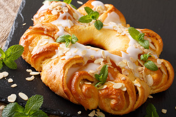 glazed brioche cake with almonds, decorated with mint closeup. horizontal