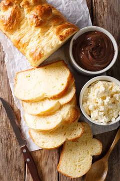French brioche bread and cream mascarpone cheese, chocolate cream close-up. Vertical top view