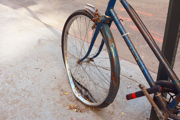 Fototapeta na wymiar Loose tyre on abandoned, rusty bicycle