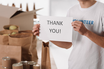 volunteer with thank you placard