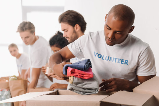 volunteer putting clothes in box