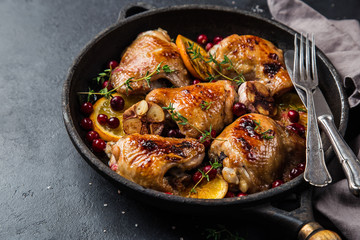 roasted  chicken with orange, cranberry and spicy herbs on pan