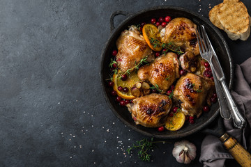 roasted  chicken with orange, cranberry and spicy herbs on pan