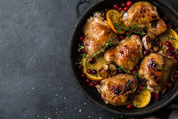 roasted  chicken with orange, cranberry and spicy herbs on pan