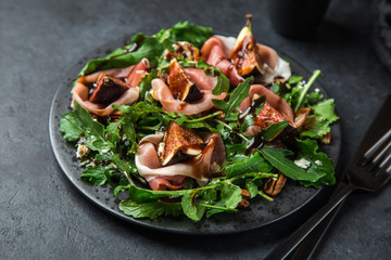 prosciutto, figs, arugula, goat cheese salad with pecan nuts and balsamic sauce