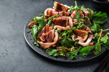 prosciutto, figs, arugula, goat cheese salad with pecan nuts and balsamic sauce