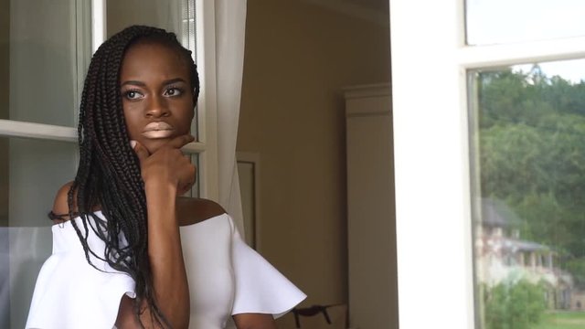 Beautiful young african american female fashion model posing indoors and waits for something