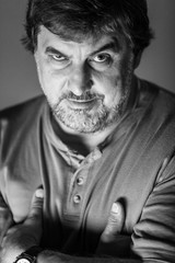 The adult brutal man is aggressively looking