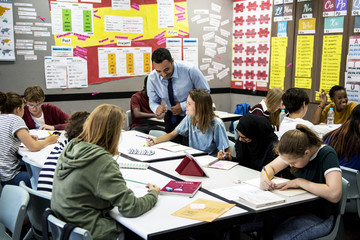 Group of students learning with their teacher