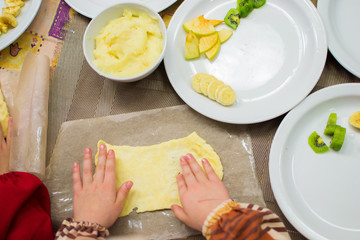 many children prepare fruit pizza at the table