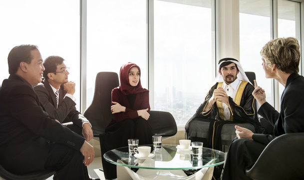 A Group Of International Business People Are Having A Round Table Meeting.