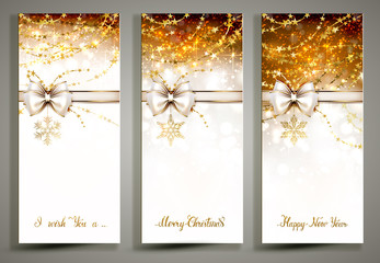 Three gold Christmas greeting cards with decorative snowflakes and white bow.