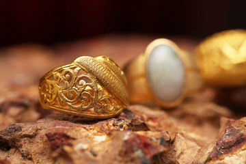 Old golden ring on stone texture