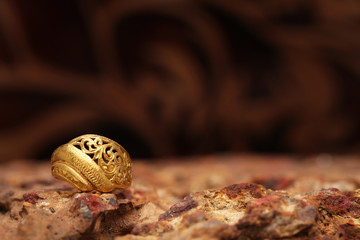 Old golden ring on stone texture