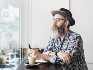 An author making notes in a coffee shop