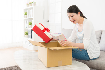 cheerful lady unpacking personal parcel at home