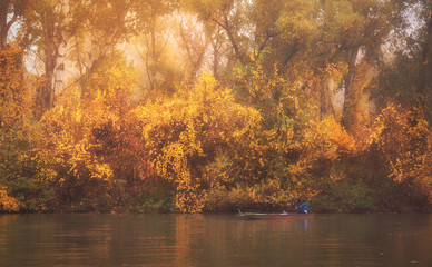 Vibrant colored photo of a fisher on the river