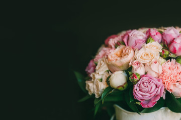 Flower arrangement of white and pink roses at the dark background. Wedding ceremony. Copy space