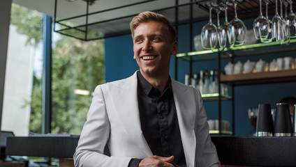 Fototapeta premium Cheerful handsome man in bar