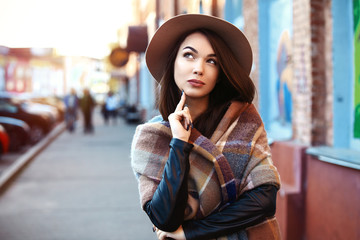 Close-up Fashion woman portrait of young pretty trendy girl posing at the city, street fashion