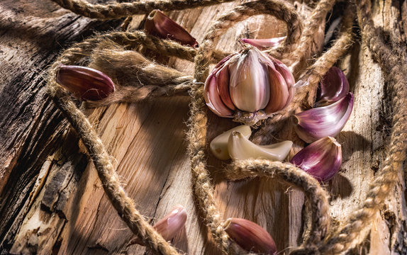 Garlic whole and cloves on the wooden background