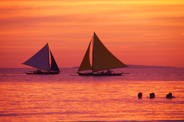 Fototapeta na wymiar Sailboats and Sunset on Boracay beach, Philippines