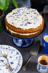 Carrot cake with coffee. Gray background, blue and white porcalain, crocery.