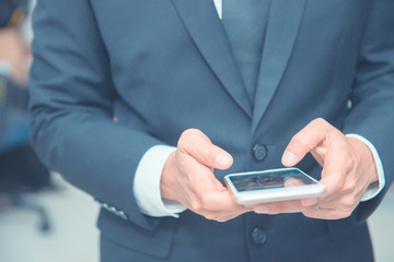 Handsome man in suit check message from mobile,smartphone for social