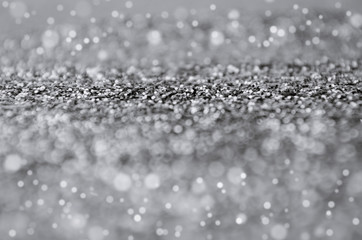 close up silver or gray shiny glitter and bokeh light texture ,christmas and new year festival, holiday abstract background, copy space for text or media content, high contrast color tone