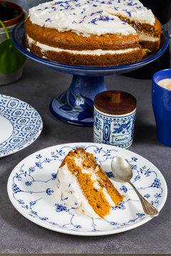 Carrot cake with coffee. Gray background, blue and white porcalain, crocery.