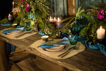 Romantic dinner setup or Holiday table setting, red decoration with candle light.