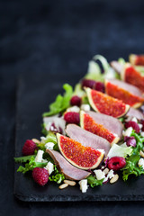 Delicious salad with fresh figs, raspberry and duck meat