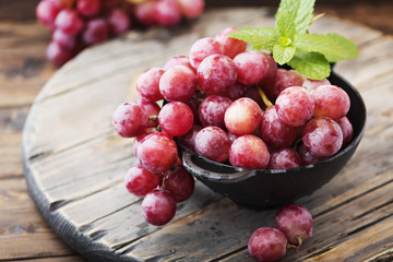 Sweet red grape on the wooden table