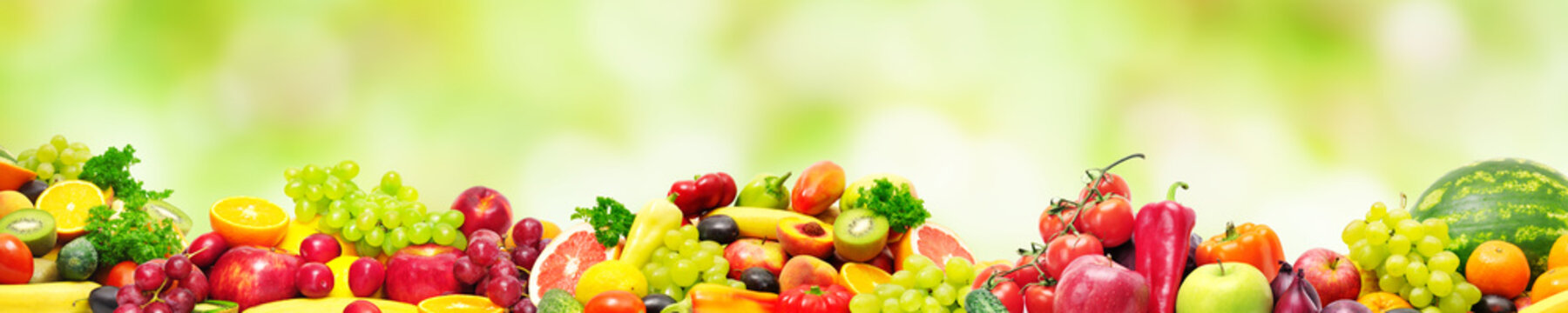 Panoramic collection fresh fruits and vegetables for skinali on blur green background.